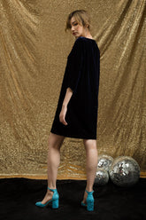 Velvet shift dress with oversized bow detail and relaxed mid-thigh silhouette for evening elegance